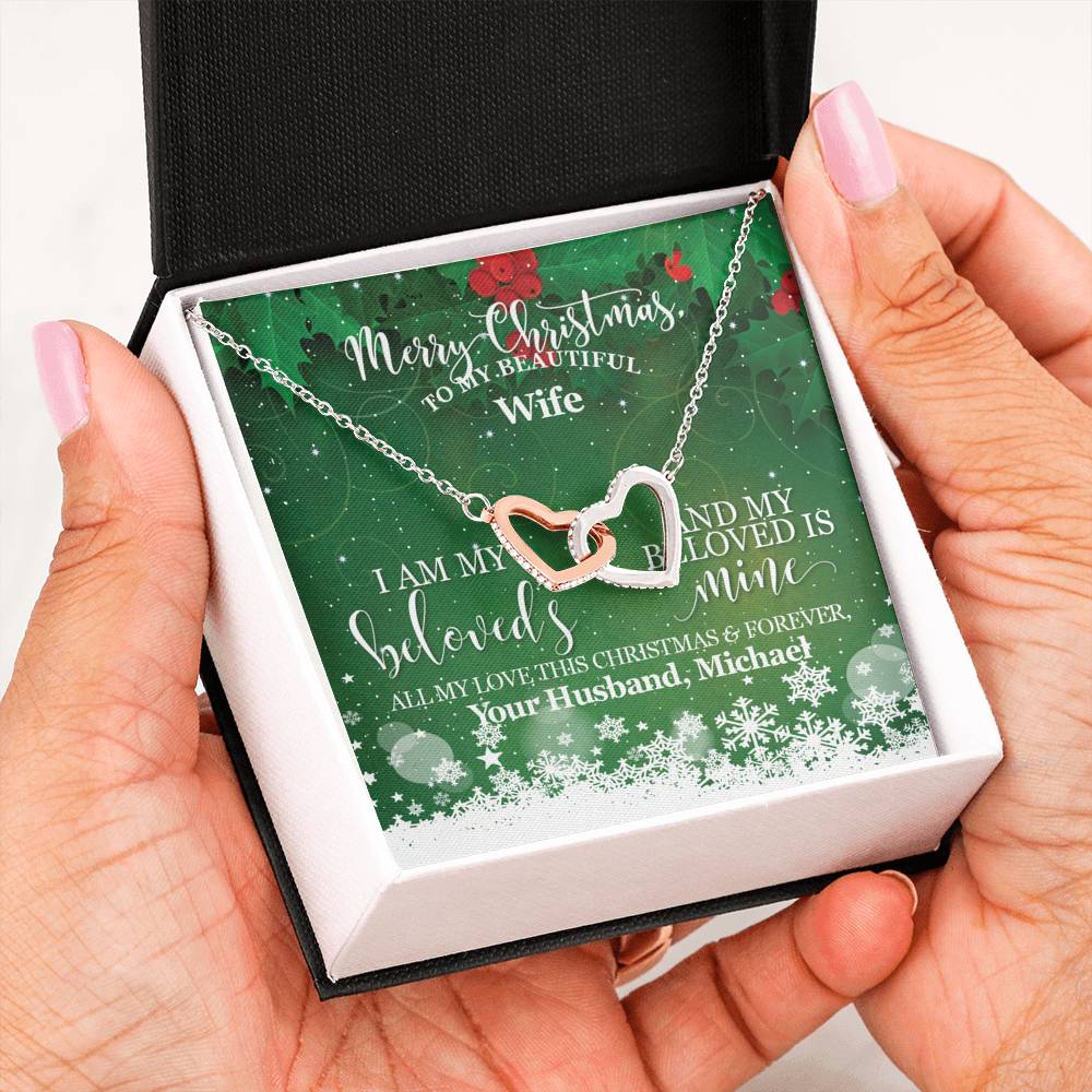 Personalize the message card with your name to create the Perfect Keepsake!The Perfect Christmas Gift for your Wife and Soulmate. Surprise her this Christmas with this Beautiful Interlocking Hearts necklace watch her heart melt when you give it to her!Two hearts embellished with Cubic Zirconia stones, interlocked together as a symbol of never-ending love.Height 0.6" (1.5cm) Width 1.1" (2.7cm) Adjustable cable chain 18"-22"