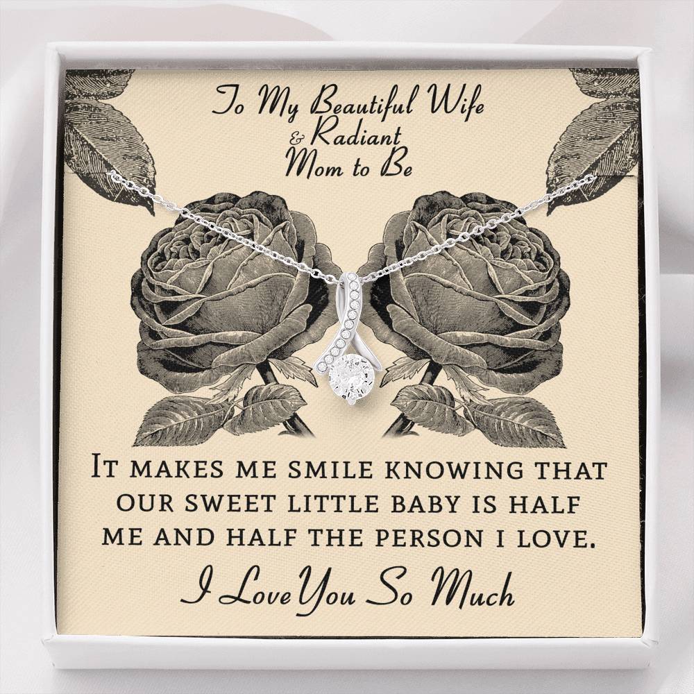 The perfect gift for your wife and mom to be.Ribbon shaped,14K white gold over stainless steel,clear crystals, a sparkling 7mm round  Cubic Zirconia.Message card that reads: "To my beautiful wife and radiant mom to be, It makes me smile knowing that our sweet little baby is half me and half the person I love. I love you so much."  