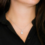 The perfect gift for your wife and mom to be.Ribbon shaped,14K white gold over stainless steel,clear crystals, a sparkling 7mm round Cubic Zirconia.Message card that reads: "To my beautiful wife and radiant mom to be, It makes me smile knowing that our sweet little baby is half me and half the person I love. I love you so much."