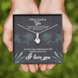 This beautiful sparkly pendant is truly is an alluring gift for your Wife, Daughter, Granddaughter, Bride To Be, Girlfriend or even for yourself. The emotions will start pouring out along with tears of joy. Comes with a Free Luxury Gift Box with the Heart Felt message as shown. The ribbon design is embellished with dainty cubic zirconia, leading your eye down to the 7mm round cut Cubic Zirconia. Crafted with 14k White Gold over Stainless Steel