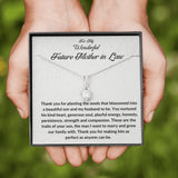 The perfect gift for your future mother in law.Ribbon shaped,14K white gold over stainless steel,clear crystals,a sparkling 7mm round Cubic Zirconia. Heartfelt message card included guaranteed to melt your new mother in laws heart.